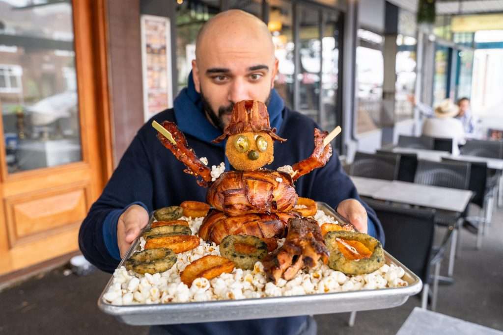 Guest holding the Porklaf BBQ snowman platter close-up